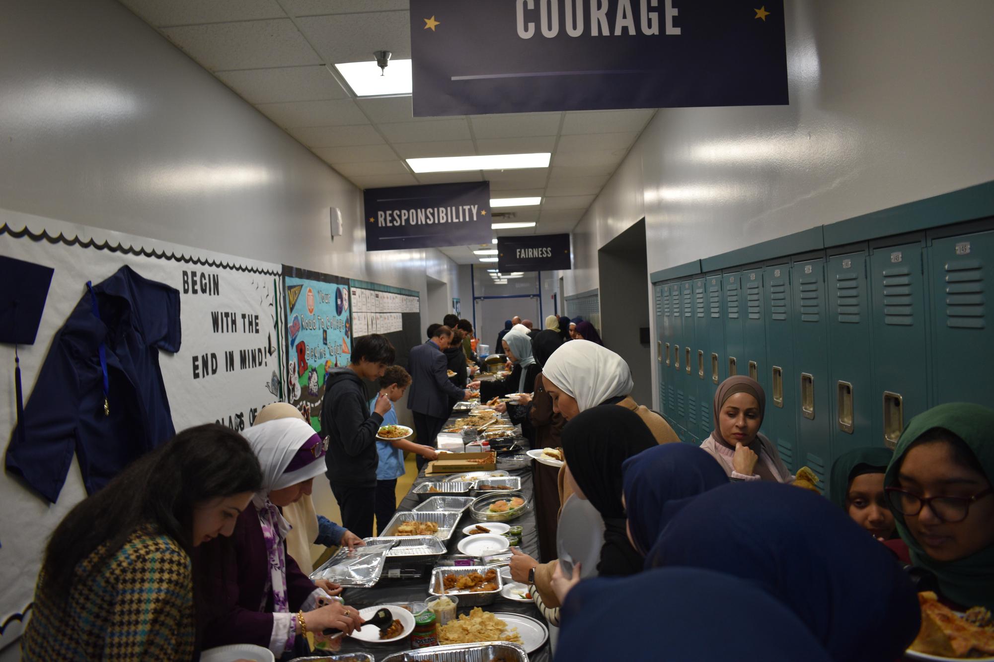 The BHA community enjoys food brought by students for a quiz pass incentive. Photo Credit: Jannah Iqbal