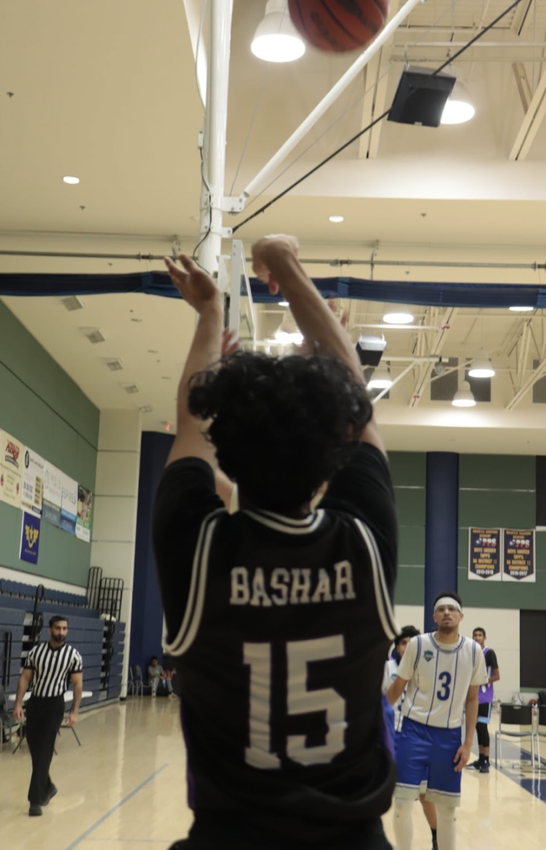 Junior, Abrar Bashar, takes a shot in an intense game against ISI at the regional MIST Boys Basketball tournament.