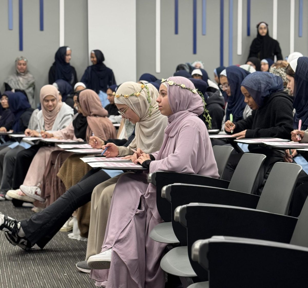 High school students participate in a bingo game led by the high school Hijab Forum MC.