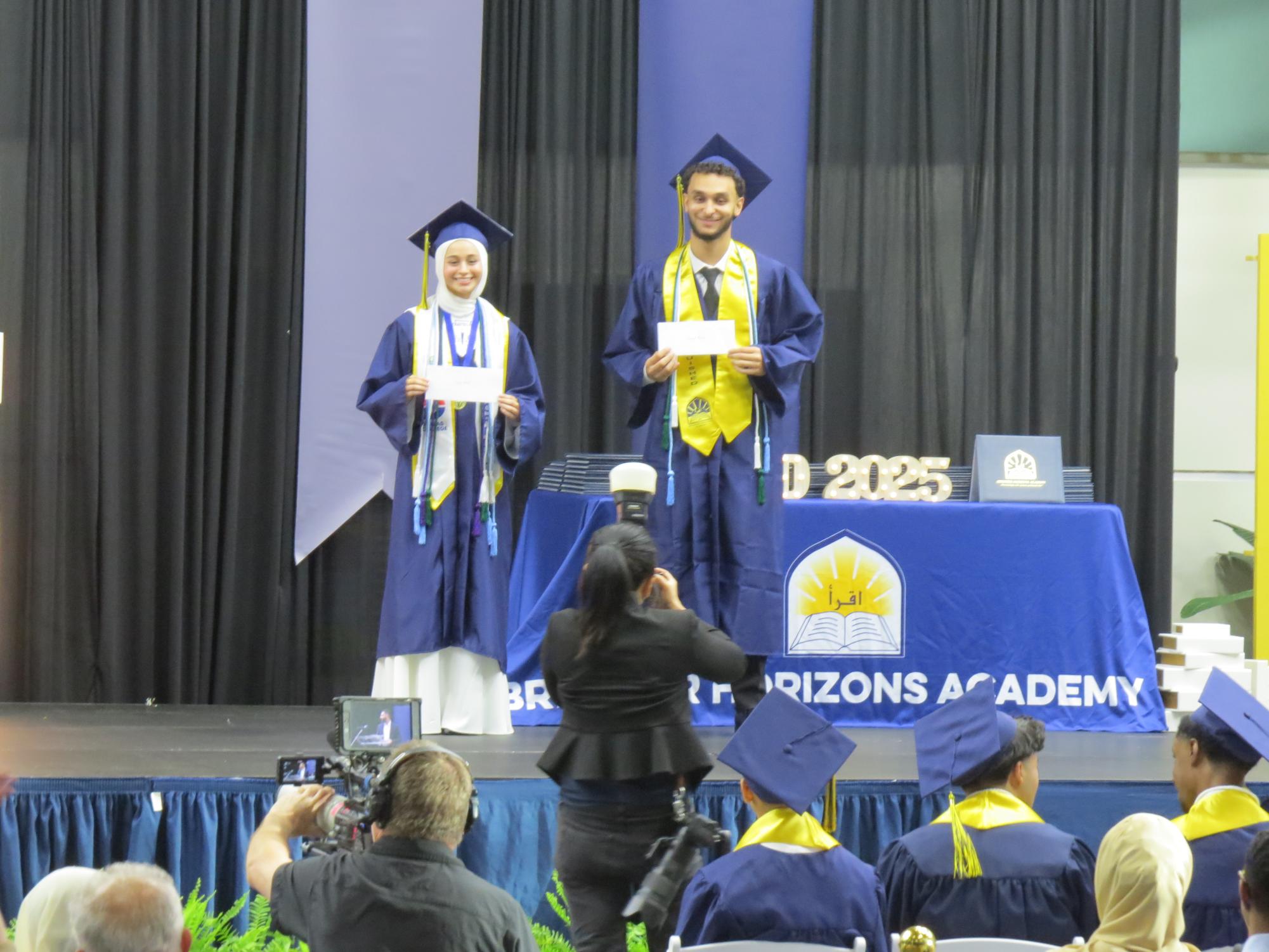Seniors Youssef Moussa and Sedra Amhan on stage after being recognized for the Athletics Scholarship.