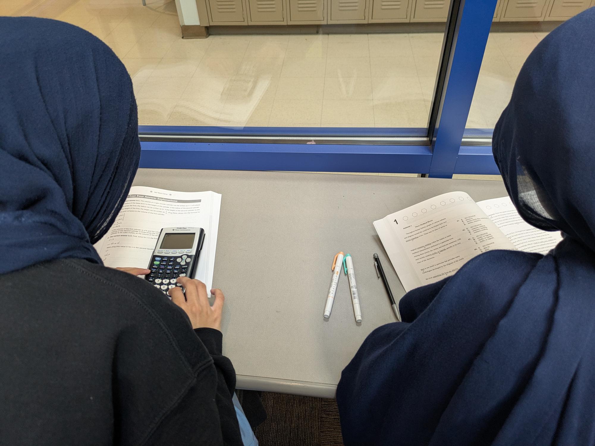 Juniors study for the SAT in the fishbowl using workbooks.