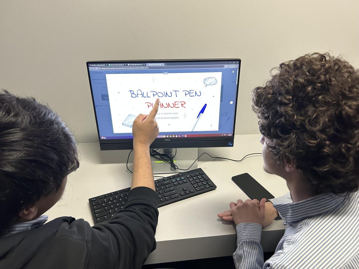 Staff writer Yusuf Madani and Mahdi Mezenner arguing over what template to use for the PowerPoint.