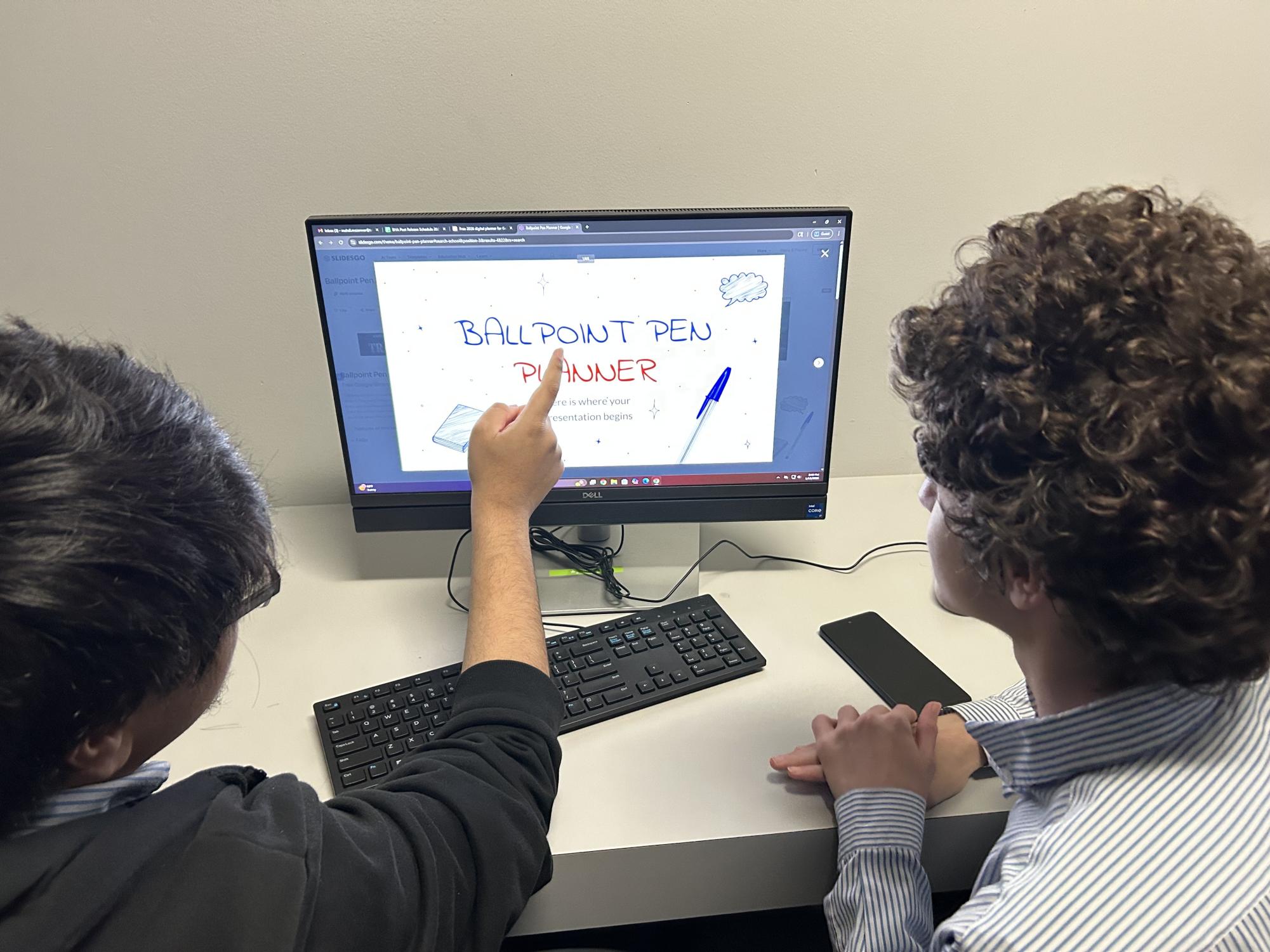Staff writer Yusuf Madani and Mahdi Mezenner arguing over what template to use for the PowerPoint.