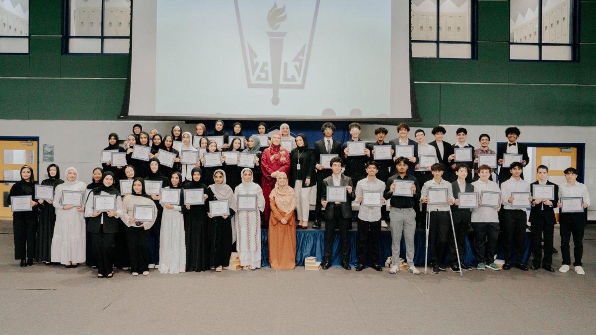 NHS inductees pose on stage after the conclusion of their ceremony. (Photo by Ms. Sundus Khan)