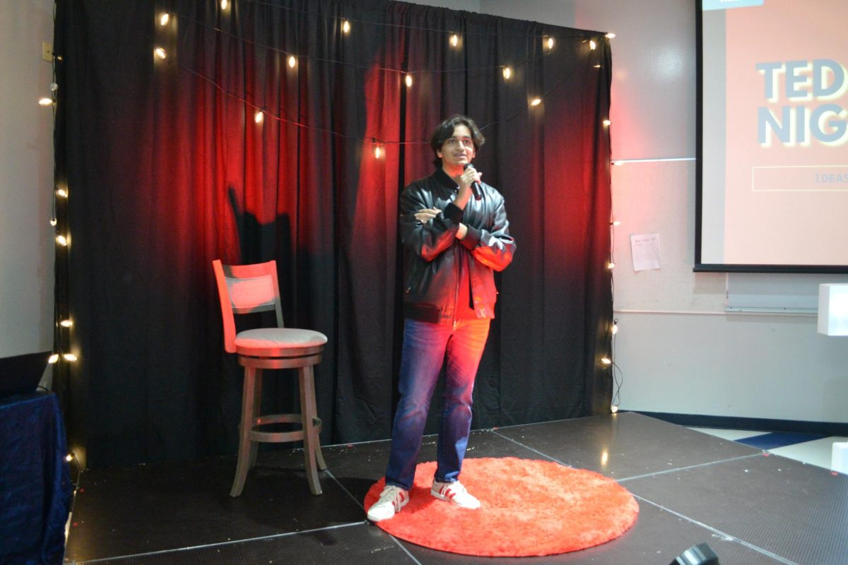 Ahmed Sajjad, The TED Talk Club President, stands on stage, ready to begin the event.