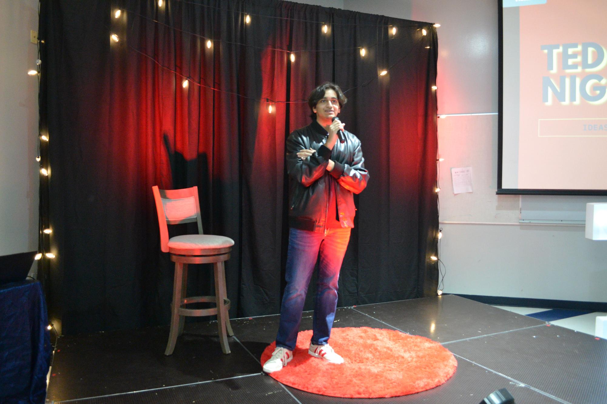 Ahmed Sajjad, The TED Talk Club President, stands on stage, ready to begin the event.