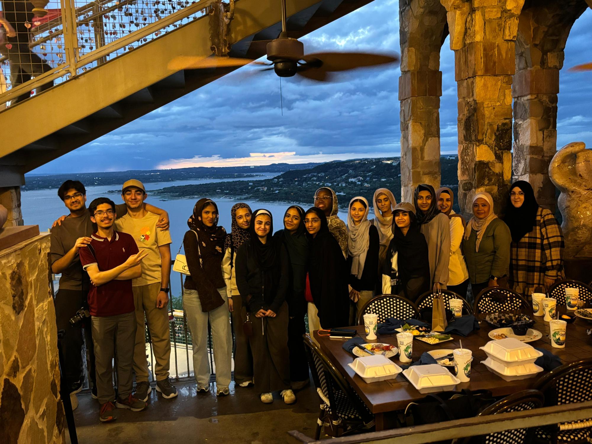 BHA Post and Yearbook Club members pose with their chaperones for a group photo at the Oasis on Lake Travis.